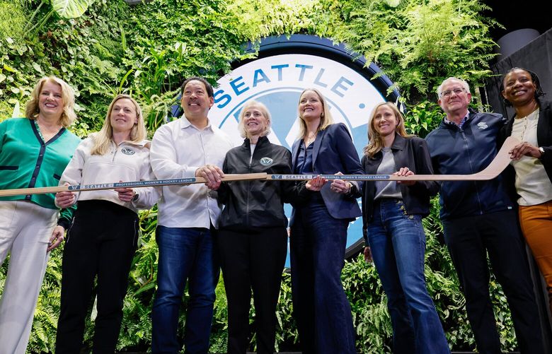 From left, President and CEO of the Seattle Sports Commission Beth Knox, PWHL Executive Vice President of hockey operations Jayna Hefford, Seattle Mayor Bruce Harrell, PWHL Executive Vice President of hockey operations Jayna Hefford, King County Executive Shannon Braddock, Seattle Kraken co-owner Samantha Holloway, Seattle Kraken CEO Tod Leiweke and Seattle councilmember Joy Hollingsworth pose for a group photo after a press conference announcing the news PWHL expansion team Wednesday, April 30, 2025 in Seattle. 229923