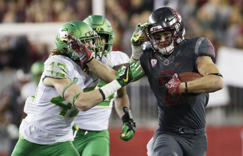 Washington State wide receiver River Cracraft tries to fend off Oregon defensive back Brenden Schooler (43) during the second half of an NCAA college football game in Pullman, Wash., Saturday, Oct. 1, 2016. Washington State won 51-33. (AP Photo/Young Kwak) WAYK120