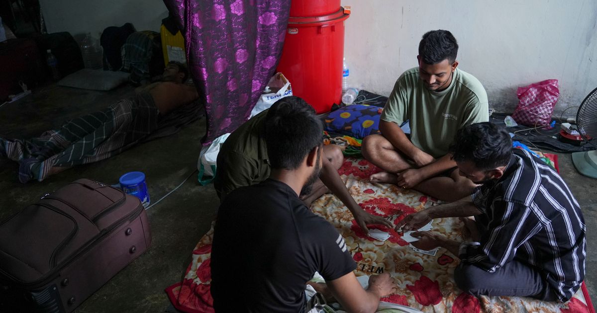 Migrant workers in Malaysia seek unpaid wages from a supplier to ...