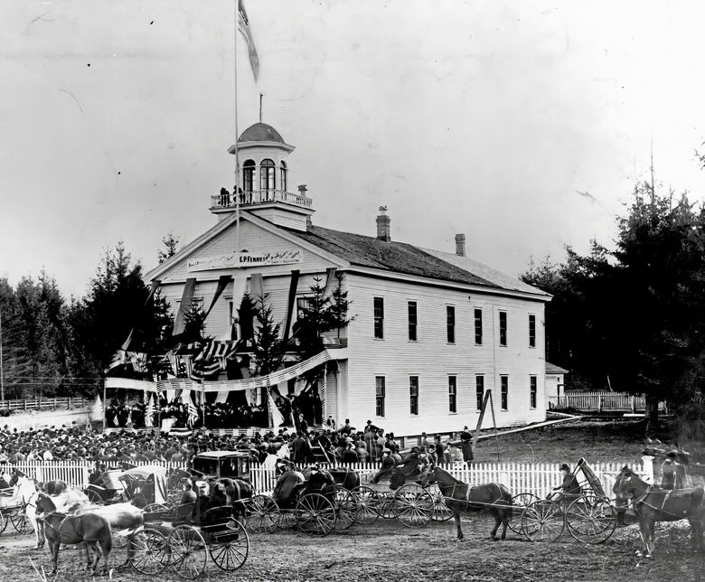 THEN: Shown Nov. 18, 1889, during the statehood celebration, this two-story wood-frame structure served first as the territorial, then the state, capitol building between 1856 and 1903. (Courtesy Washington State Historical Society) 