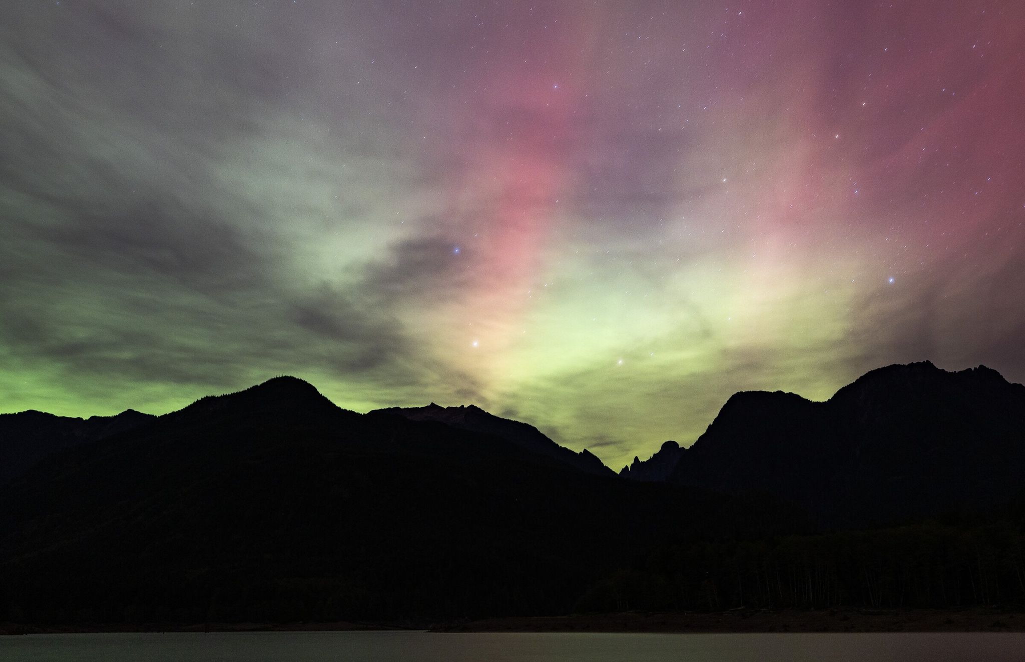 The northern lights appear over Spada Lake on Friday, Oct. 11, 2024, near Sultan in Snohomish County. (Nick Wagner / The Seattle Times)