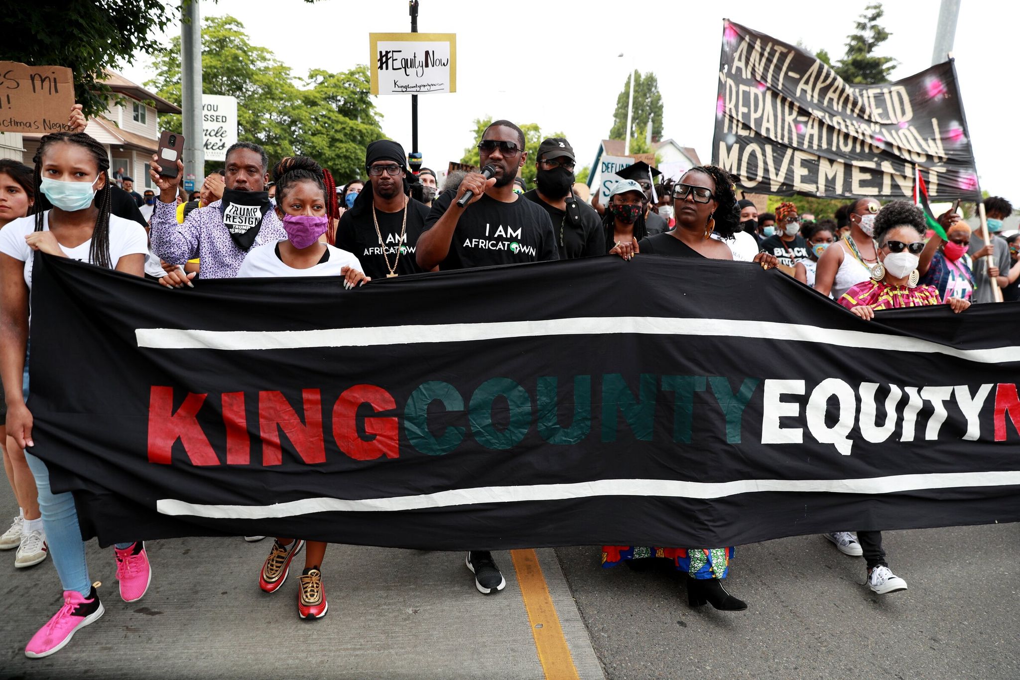 Africatown’s K. Wyking Garrett, center, leads marchers at the Juneteenth Freedom March & Celebration in Seattle Friday. For the first time in history, Washington state will conduct a study and develop proposals for reparations to descendants of chattel slavery. (Erika Schultz / The Seattle Times, 2020)
