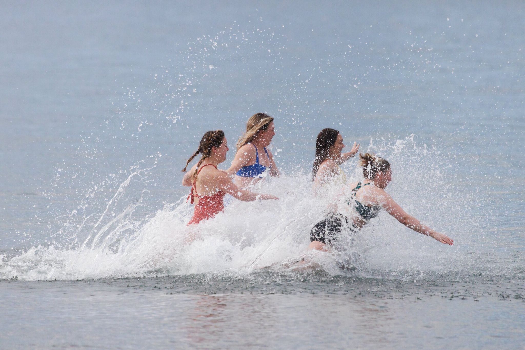 Crowds plunge into Puget Sound during the Alki Beach Polar Bear Swim on Jan 1. (Erika Schultz / The Seattle Times)