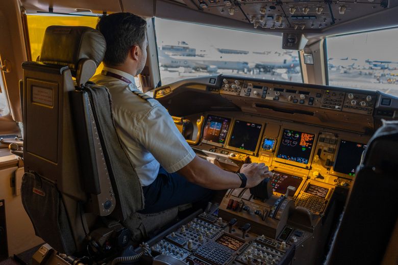 A pilot on the flight deck of a Boeing 777-300 aircraft, operated by Qatar Airways, at the Paris Air Show. (Nathan Laine / Bloomberg)