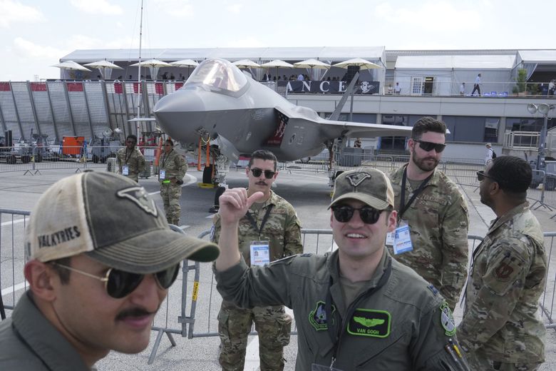 U.S. service members stand by a F-35A jet fighter on display at the Paris Air Show on Monday. (Michel Euler / The Associated Press)