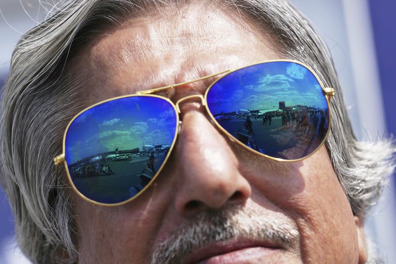 Planes at the Paris Air Show are reflected on an onlooker&#8217;s sunglasses Monday in Le Bourget, north of Paris.  (Thibault Camus / The Associated Press)