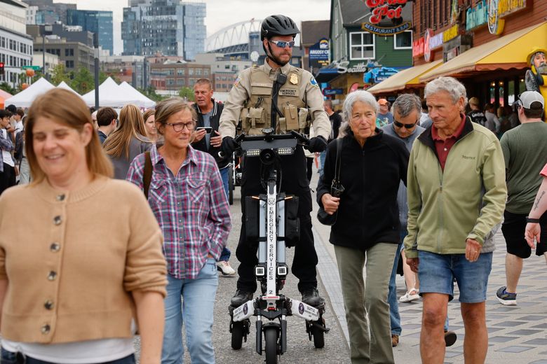 Lt. Jamie Smith, with Seattle Center’s Emergency Services Unit, patrols Waterfront Park on a Trikke. (Karen Ducey / The Seattle Times)