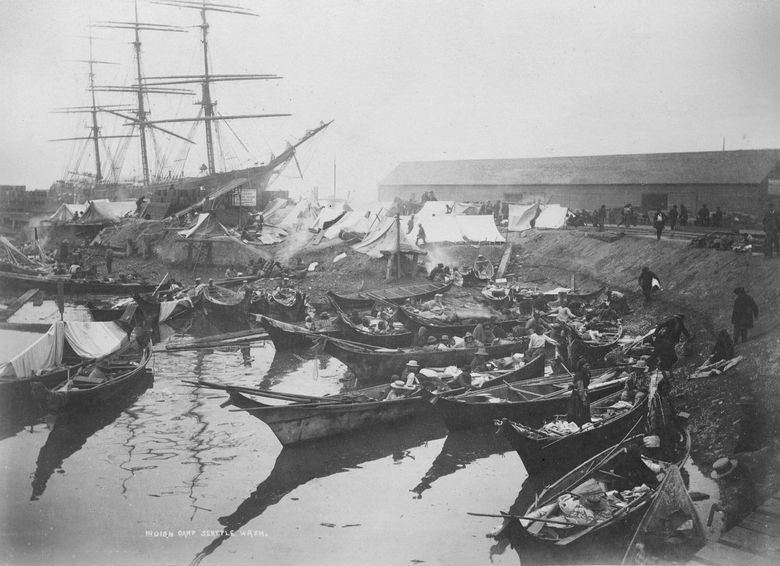 Native people camp with canoes at Ballast Island, at the foot of Washington Street in Seattle, circa 1890. (Family papers of David Thomas Denny II / MOHAI)