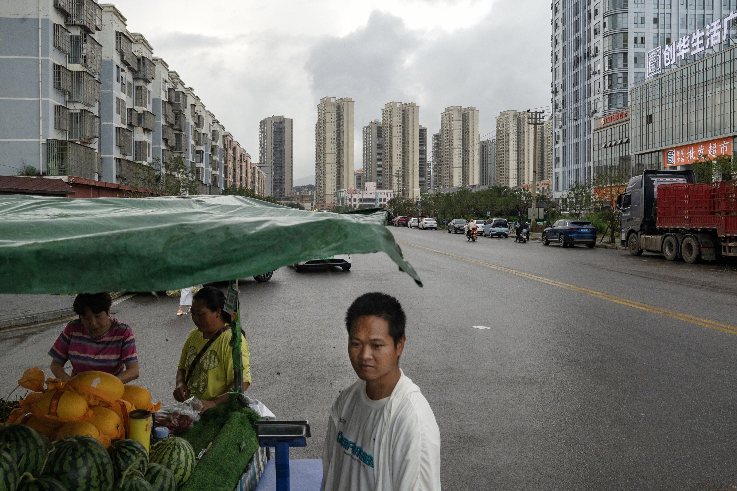 A produce market among the residential high-rises where Chen Tianming’s neighbors moved after their homes were demolished, in Xingyi, China July 1. (Andrea Verdelli / The New York Times)
