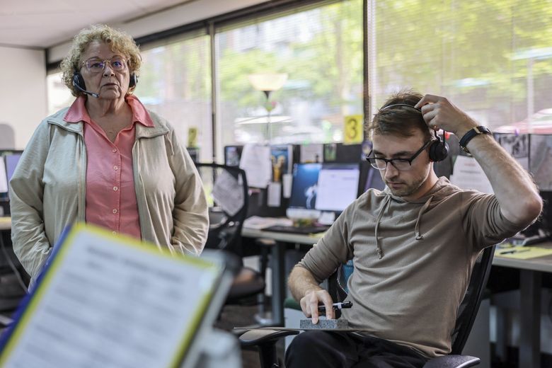 At Crisis Connections in Seattle, workers take calls with help from their colleagues, who listen in and offer support. Crisis Connections has run the local suicide lifeline for decades, and since December has been dispatching mobile crisis teams throughout the county. (Kevin Clark / The Seattle Times)