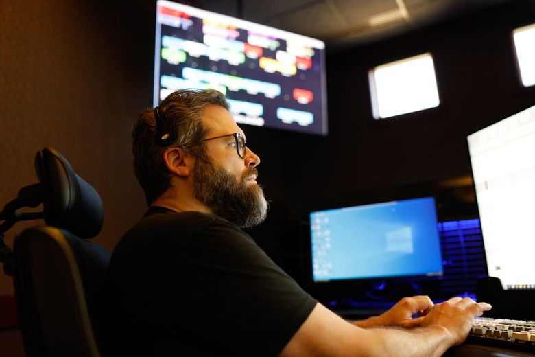 Peter Permenter responds to emergencies at the Valley Communications Center in Kent. (Karen Ducey / The Seattle Times)