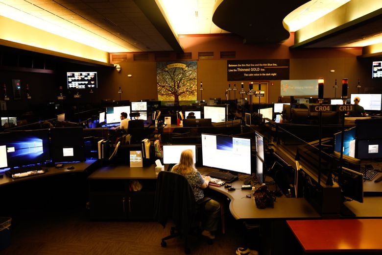 Call receivers and dispatchers at the Valley Communications Center in Kent, which serves communities in South King County. (Karen Ducey / The Seattle Times)