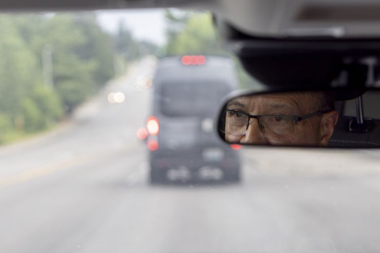 Joe Vela, crisis services director of Sound Behavioral Health’s mobile crisis team, follows the team’s crisis van on the way to respond to a dispatch last month in South King County. (Akash Pamarthy / The Seattle Times)