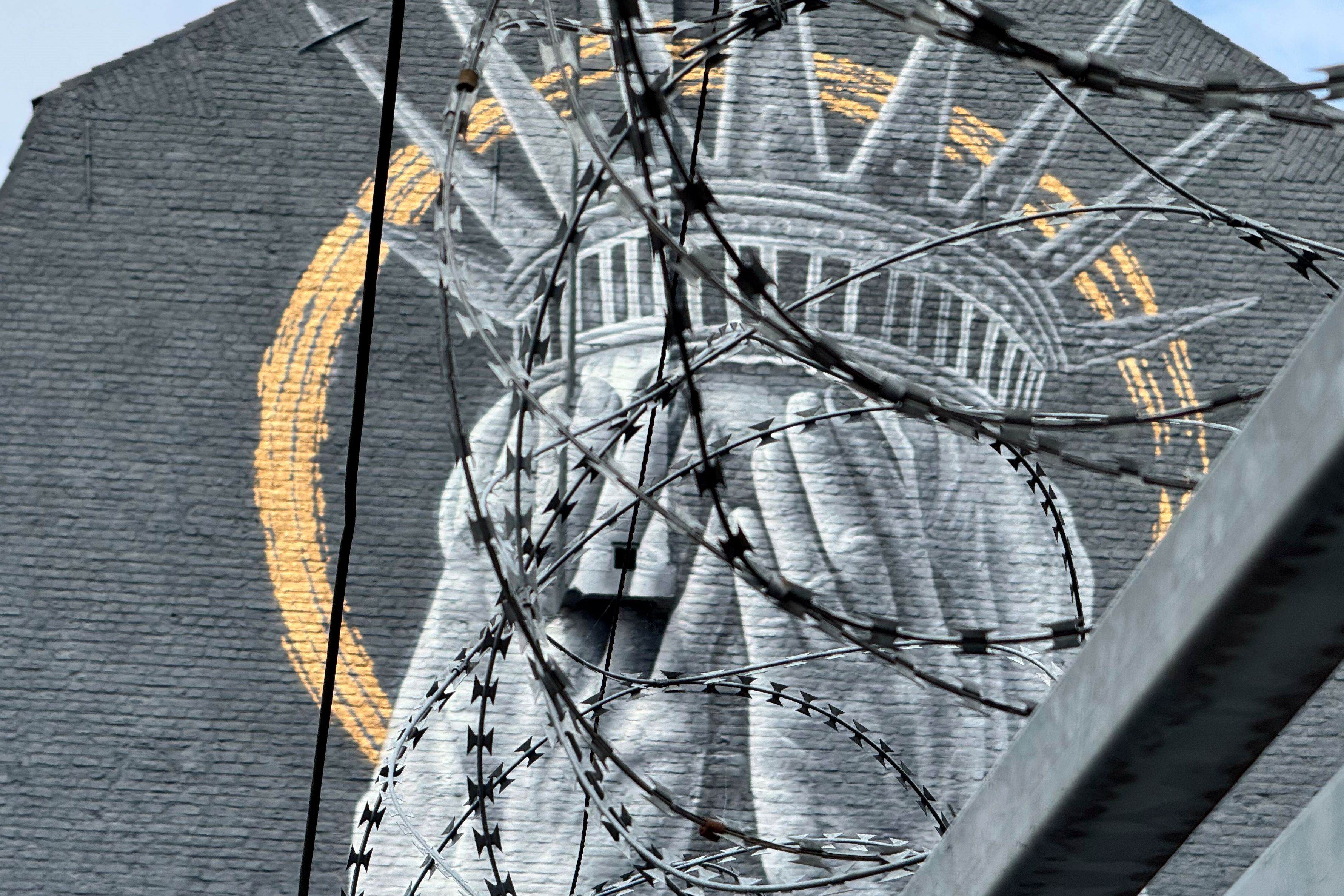A new mural in France shows the Statue of Liberty covering her