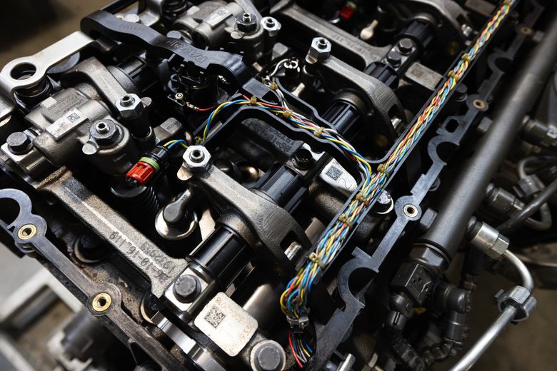 A donated Paccar MX-11 diesel engine has been opened up, exposing the wires for the electronically managed fuel injection and engine brakes, at South Seattle College in July. (Ken Lambert / The Seattle Times)