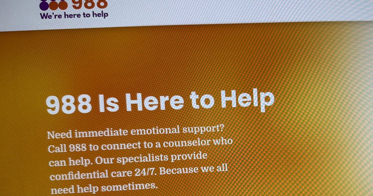 An older adult sitting on a park bench, looking thoughtful