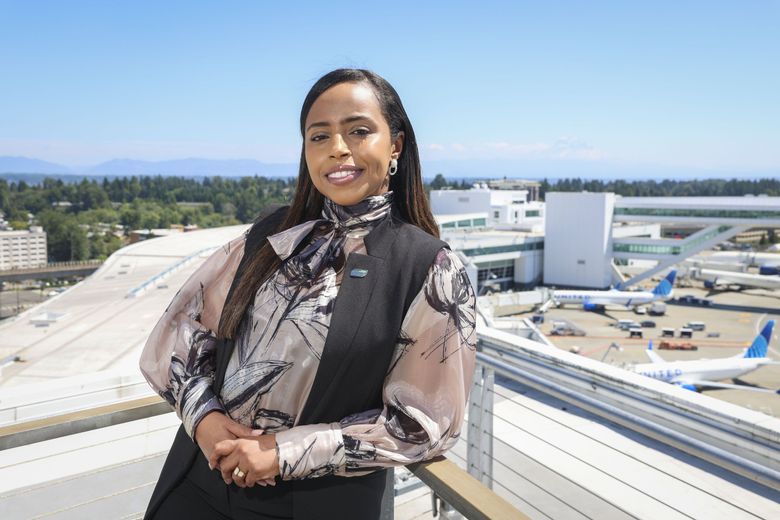 Port of Seattle Commissioner Hamdi Mohamed at Seattle-Tacoma International Airport in July. The international arrivals terminal is behind her. (Ivy Ceballo / The Seattle Times)