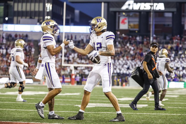 Demond Williams Jr., left, and Denzel Boston congratulate each other on the seven-yard touchdown reception in the fourth quarter.  The Washington Huskies played the Washington State University Cougars in the annual Apple Cup Game Saturday, Sept. 20, 2025, at Martin Stadium, in Pullman. (Dean Rutz / The Seattle Times)