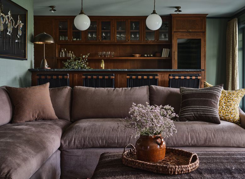 What was previously an unfinished basement is now a family gathering space for hanging out and watching TV. Srilakshmi Remala and Viren Kamdar built the speakeasy-inspired bar to aid in casual entertaining. (Michael Clifford)