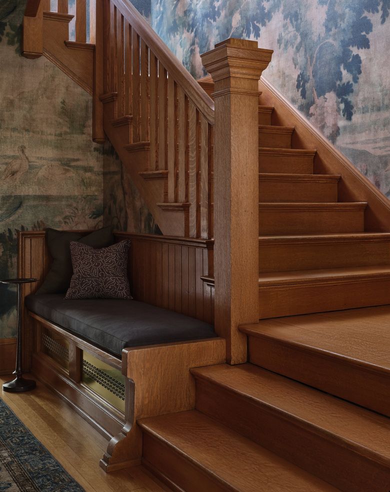 Dramatic wallpaper balances out the wood tones of the home’s traditional trim and millwork. (Michael Clifford)