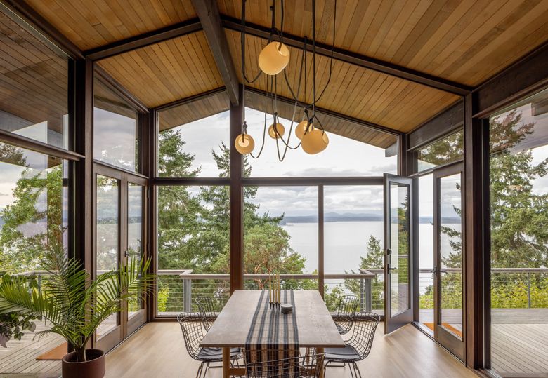 In West Seattle, Paul Midgen and Kirsten Adams had to reflect on whether they were truly ready to own a home with so many glass walls. (Rafael Soldi)