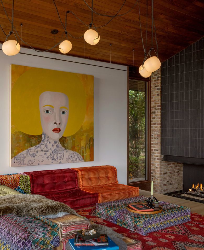 Custom art and a low-slung couch add color amid the living room’s neutral palette in a midcentury home in West Seattle. (Rafael Soldi)