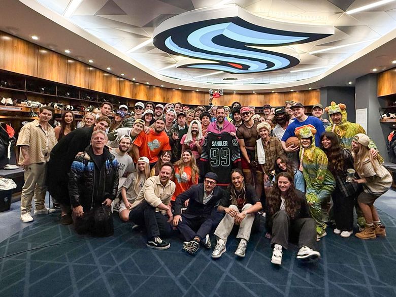 Adam Sandler poses with Seattle Kraken players after the team attended Sandler’s show at Climate Pledge Arena dressed up as various characters from his movies. (Seattle Kraken / Climate Pledge Arena)