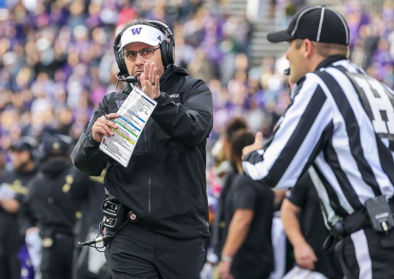 Coach Jedd Fisch runs down the sideline to call a timeout in the fourth quarter of UW’s win over Illinois last weekend at Husky Stadium. (Dean Rutz / The Seattle Times)