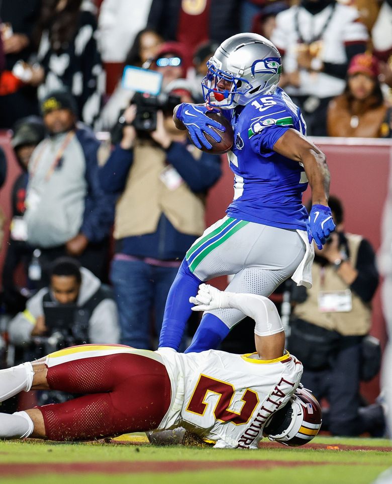 Tory Horton scores on a 4-yard pass from Sam Darnold in the first quarter Sunday en route to a win against the Commanders. (Dean Rutz / The Seattle Times)