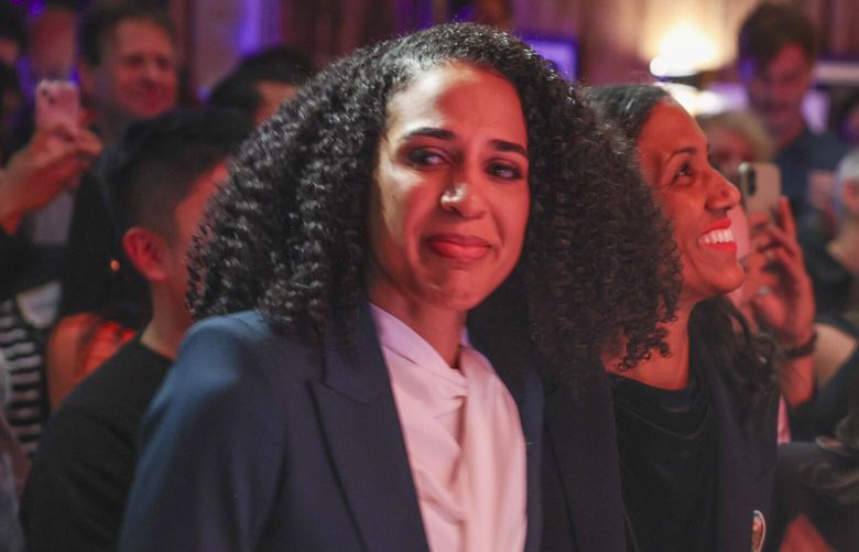 From left: Seattle city attorney challenger Erika Evans, councilmember position 9 candidate Dionne Foster and councilmember position 8 incumbent Alexis Mercedes Rinck, and councilmember position 9 candidate Dionne Foster react as results are read during an Election Day party at Black and Tan Hall in Seattle  on Tuesday, November 4, 2025. 

 231562