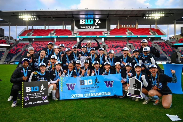 The Washington women’s soccer team poses with the banner after beating Michigan State to win the Big Ten tournament championship on Sunday at Energizer Park in St. Louis, Mo. (Joe Puetz / UW Athletics)