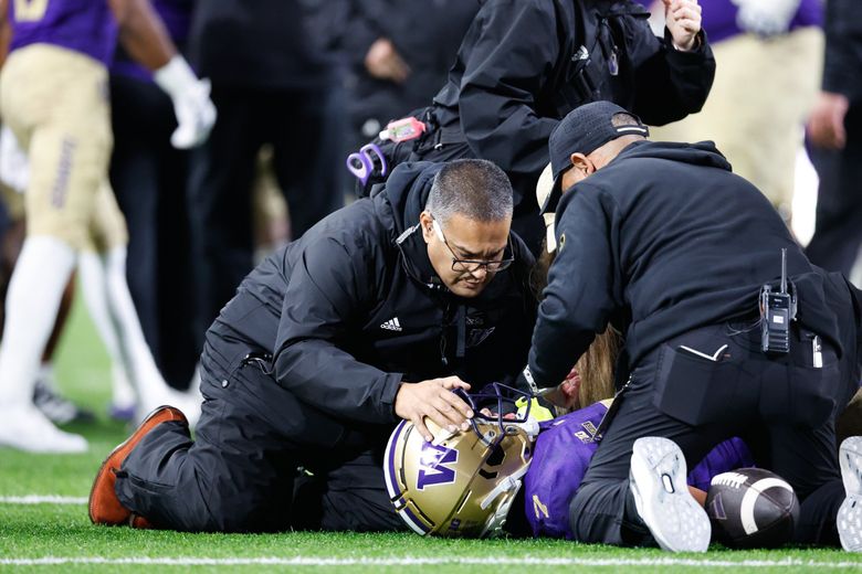 Trainers check on Raiden Vines-Bright at a game against the Purdue Boilermakers Saturday at Husky Stadium, in Seattle. (Dean Rutz / The Seattle Times)