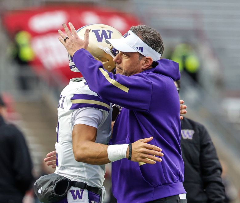 Washington coach Jedd Fisch hugs quarterback Demond Williams Jr. before the start of a game against Wisconsin on, Nov. 8, 2025, at Camp Randall Stadium in Madison, Wisc. (Dean Rutz / The Seattle Times)