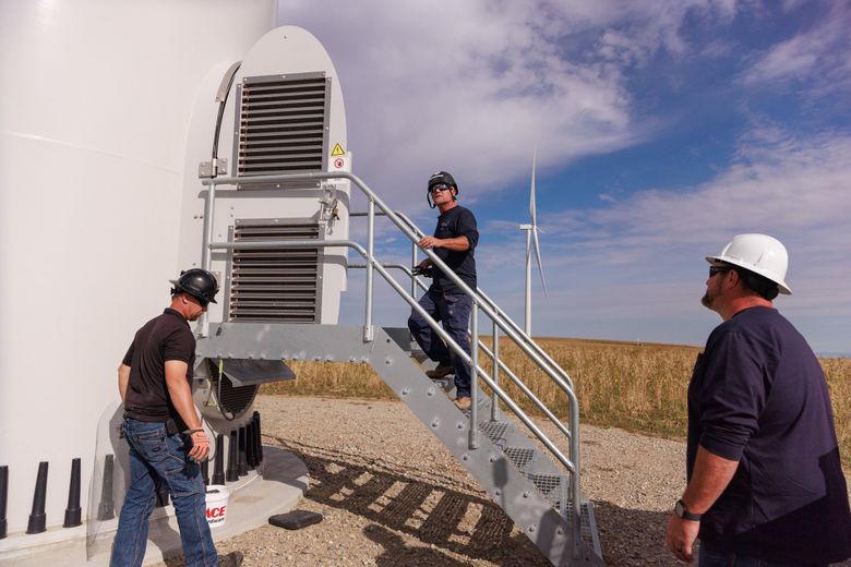 Project coordinator Nicholas Cazier, from left, turbine inspector Robert Shoemaker and Kyle Sullivan, now plant manager, work at mouse mitigation and inspections at the Beaver Creek wind farm in Stillwater County, Mont. (Erika Schultz / The Seattle Times)