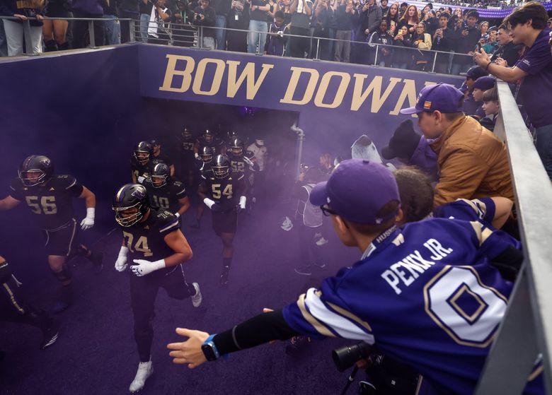Washington players take the field before a college football game against Rutgers in October. (Nick Wagner / The Seattle Times)