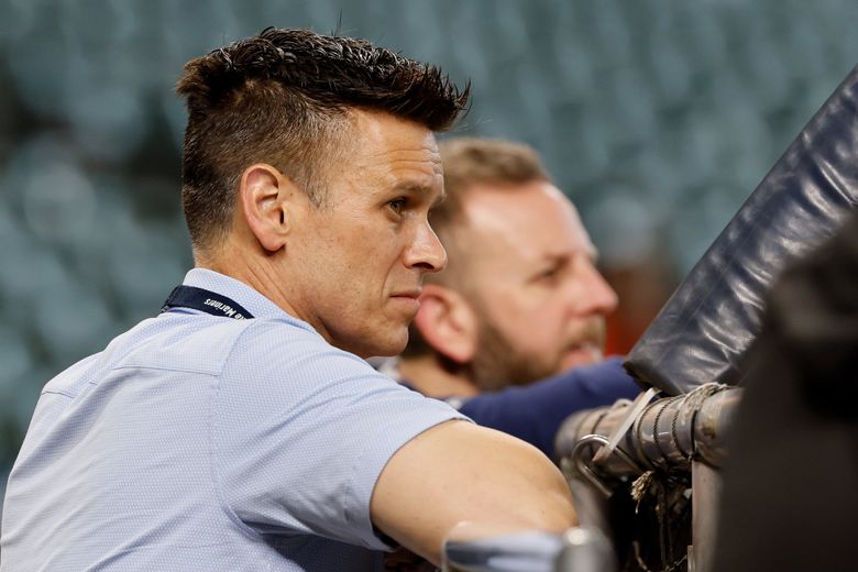 Seattle Mariners president Jerry Dipoto, left, and general manager Justin Hollander watch batting practice before the start of a game against the Houston Astros, Sept. 20, 2025 in Houston. (Jennifer Buchanan / The Seattle Times)