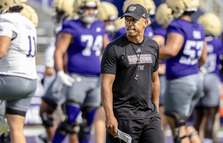 Washington defensive coordinator Ryan Walters watches players warm up during practice, July 31, 2025, in Seattle. (Nick Wagner / The Seattle Times)