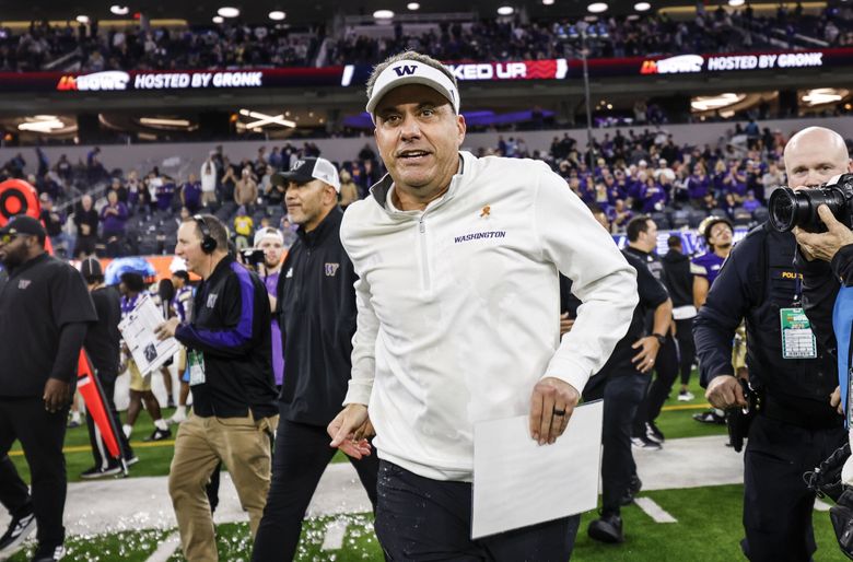 Jedd Fisch runs onto the field after Washington defeated Boise State 38-10 in the LA Bowl at SoFi Stadium in Inglewood, CA. (Dean Rutz / The Seattle Times)