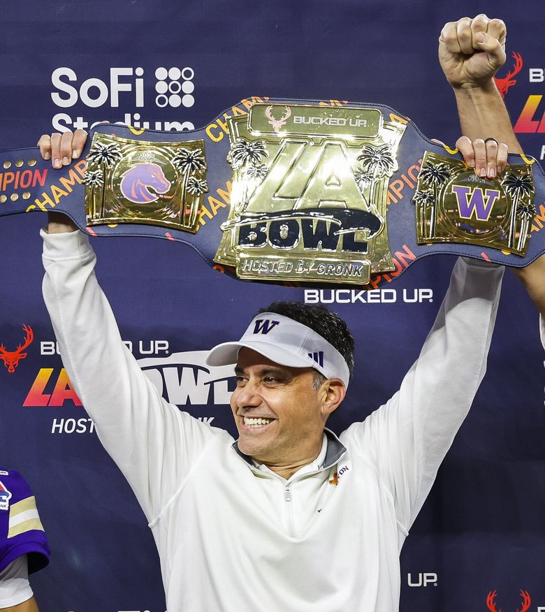 Jedd Fisch raises the LA Bowl Championship Belt for beating Boises State 38-10. The Boise State Broncos played the Washington Huskies in the Bucked Up LA Bowl, hosted by Gronk, Saturday at SoFi Stadium, in Inglewood, CA. (Dean Rutz / The Seattle Times)
