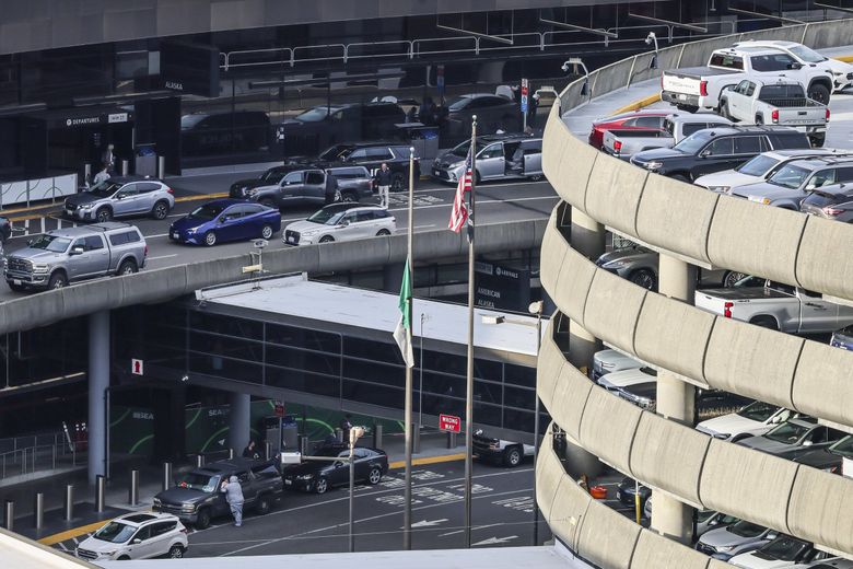 Departures Drive above, Arrivals Drive below and the gargantuan parking garage are always busy at Sea-Tac Airport. (Kevin Clark / The Seattle Times)