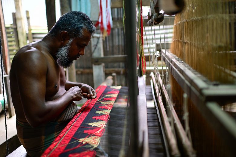 Handloom weaver working on traditional border saree
