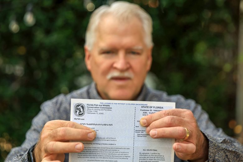 Joel Cleveland poses with his Florida bear hunting permit Friday, Dec. 5, 2025, in Tampa, Fla. (AP Photo/Mike Carlson)