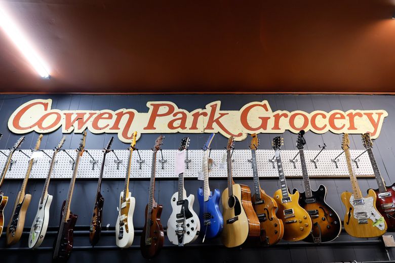 The new Re-Animated Music is in the space of the former Cowen Park Grocery. The owners decided to keep the sign, and it hangs in the back room of the new shop. (Jennifer Buchanan / The Seattle Times)