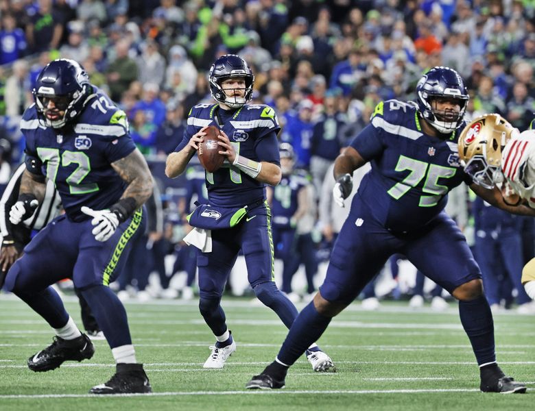Seahawks' Sam Darnold overcomes injury scare to earn first playoff win |  The Seattle Times