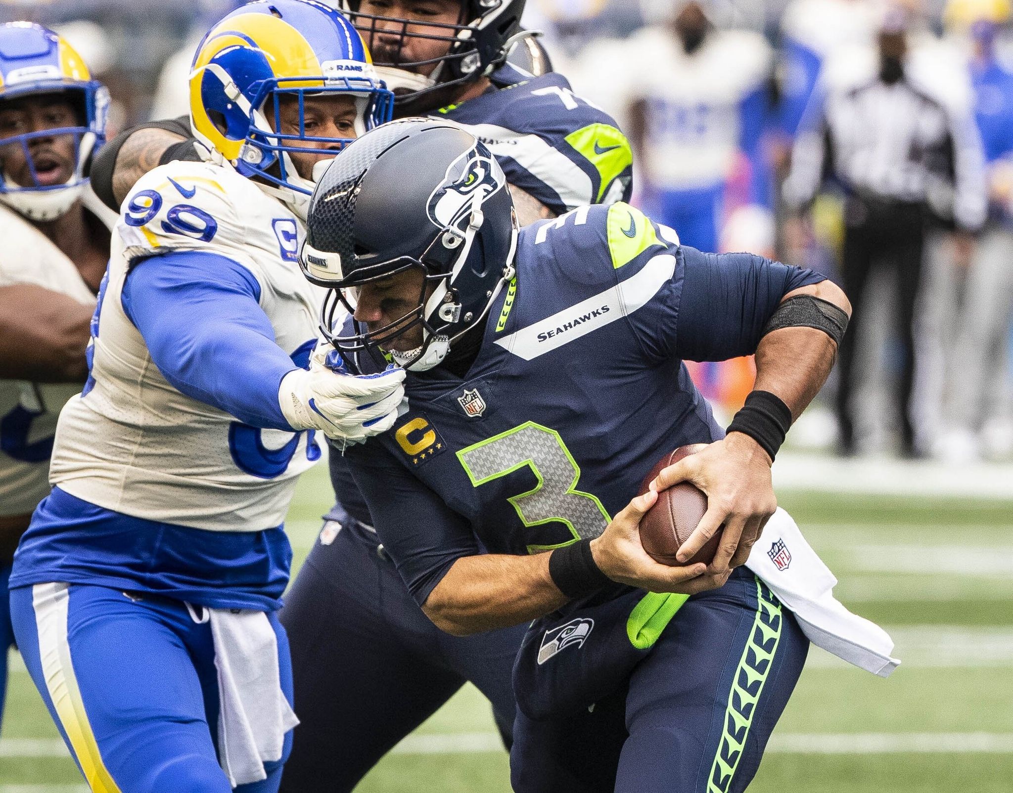 Rams defender Aaron Donald knocks Seahawks quarterback Russell Wilson (3) down at the 1-yard line in the first quarter of a wild-card playoff game on Jan. 9, 2021, at Lumen Field. (Dean Rutz / The Seattle Times)