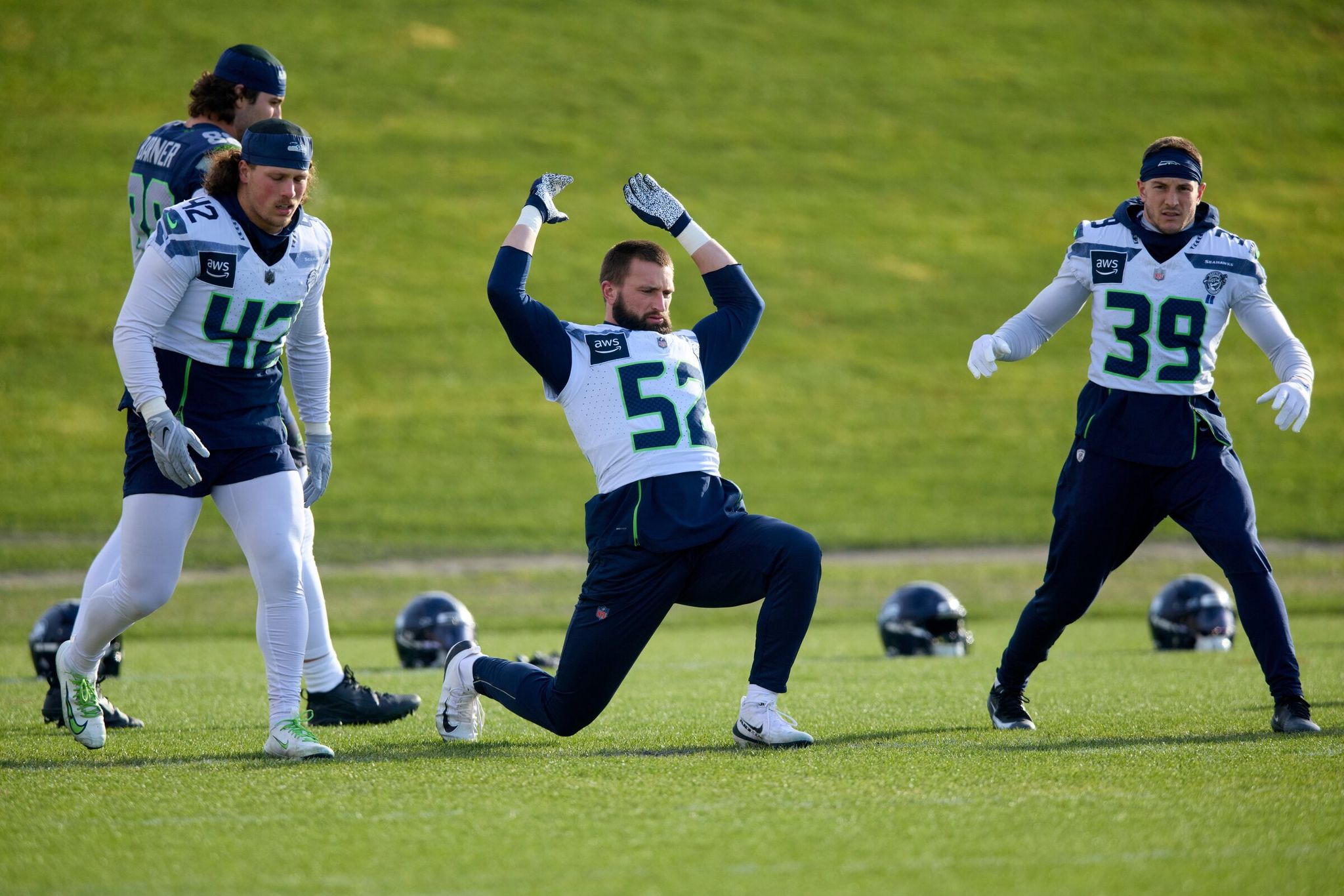 Seahawks linebackers Drake Thomas (42), Patrick O'Connell (52) and safety Tai Okada (39) warm up during a team practice at the Renton facility on Thursday, Jan. 22, before Sunday’s NFC championship game at home against the Los Angeles Rams. (John Froschauer / The Associated Press)