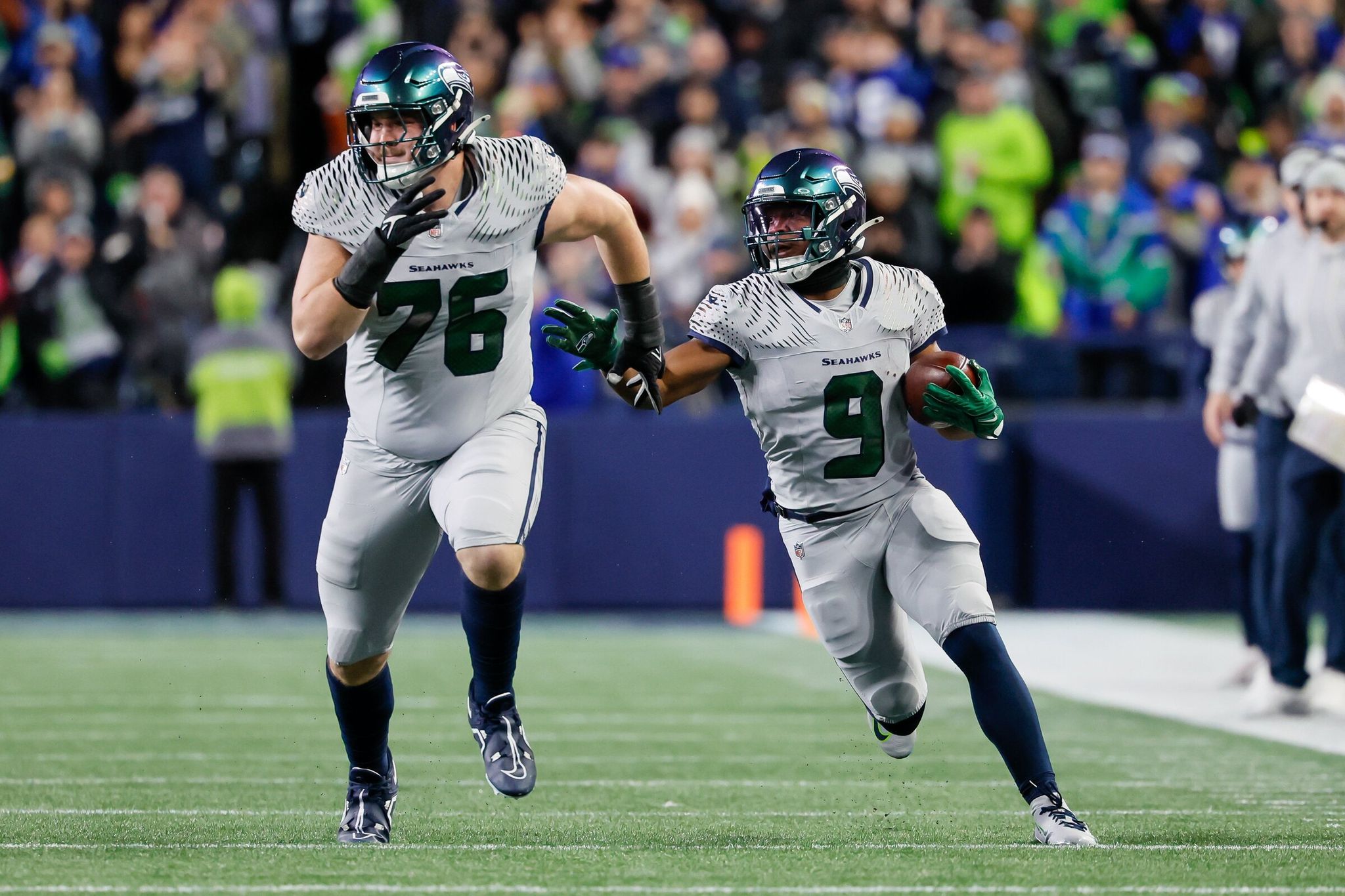 Seattle Seahawks running back Kenneth Walker III uses guard Trey Zabel as a blocker on a 46-yard run in the first quarter on Thursday, Dec. 18, 2025, in Seattle. 232106 (Jennifer Buchanan / The Seattle Times)