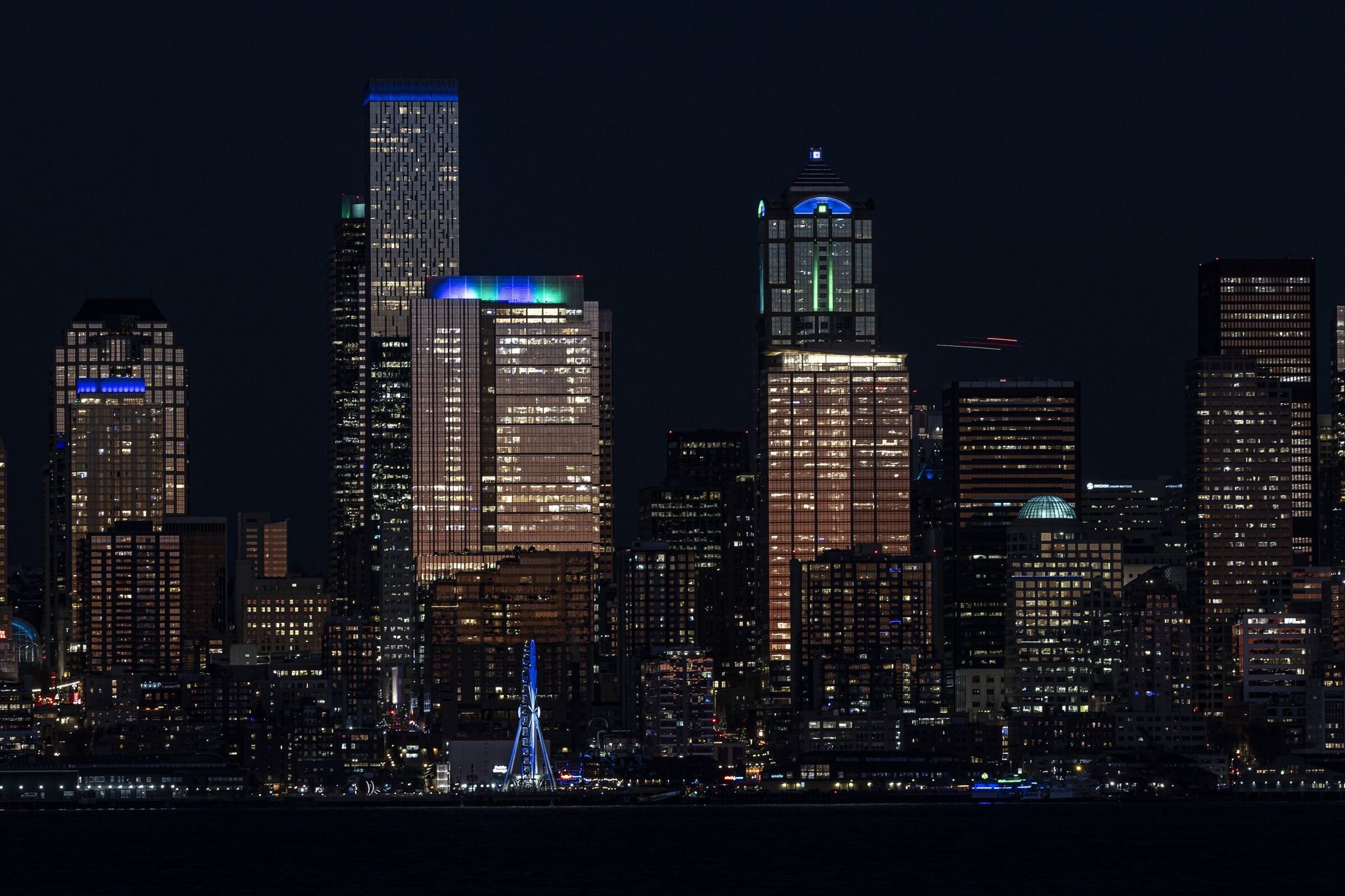 Windows at JPMorgan Chase Center were lit up Friday evening to create a multi‑story display of the ‘12th Man’ in support of the Seattle Seahawks, who will play the Los Angeles Rams in the NFC championship game on Sunday. (Kevin Clark / The Seattle Times)