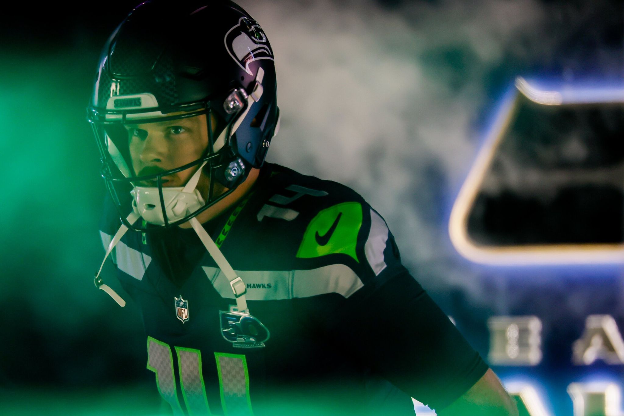 Seahawks quarterback Sam Darnold runs out of the tunnel during player introductions on Saturday. (Jennifer Buchanan / The Seattle Times)