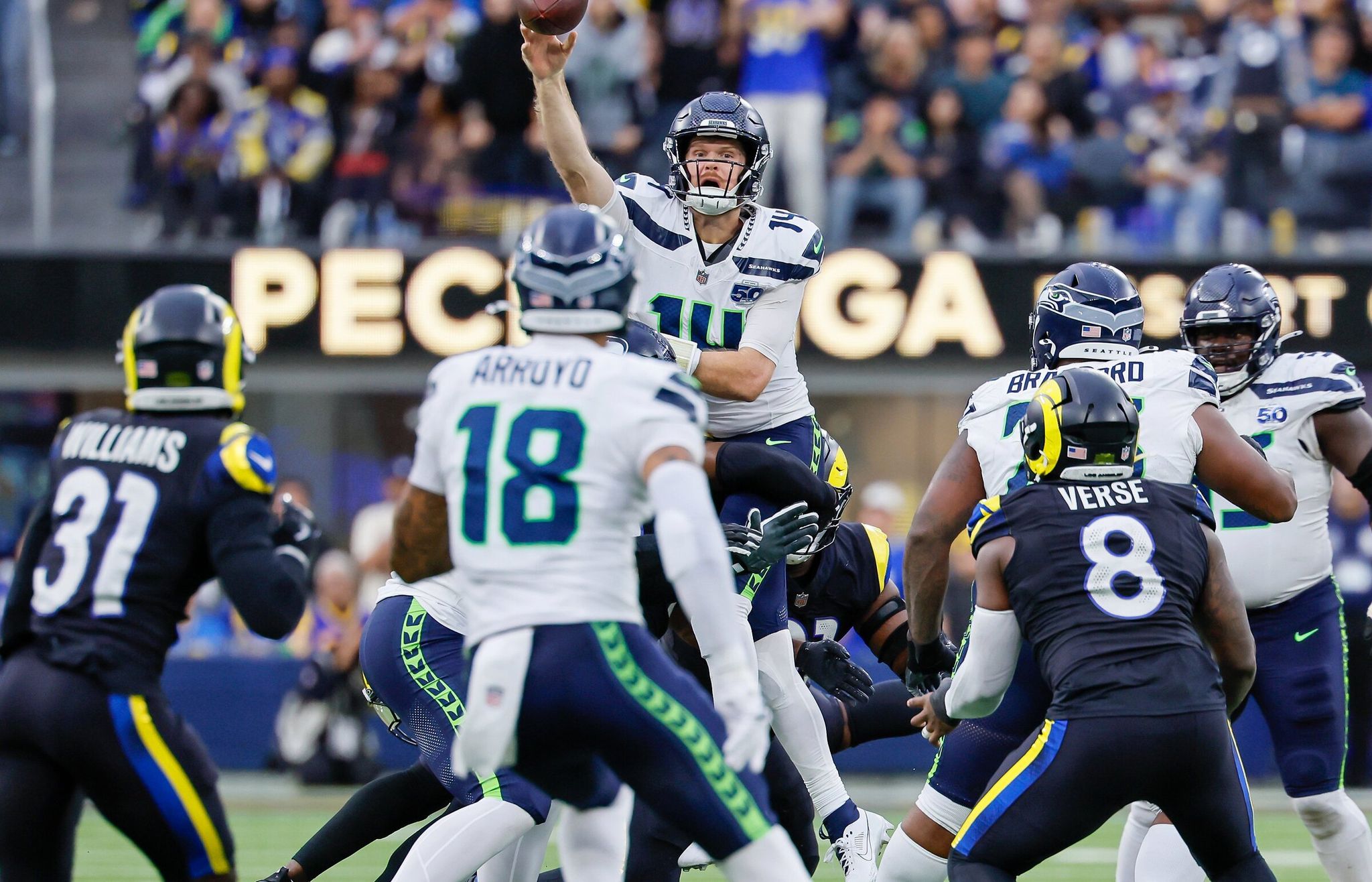 Seattle Seahawks quarterback Sam Darnold rises into the air as Los Angeles Rams defenders surround him from below and he throws his fourth interception to Rams cornerback Darius Williams, left, in the fourth quarter on Sunday, Nov. 16, 2025, in Inglewood, Calif. (Jennifer Buchanan / The Seattle Times)